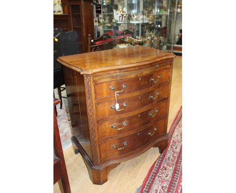 Gentleman's serpentine chest of drawers with vanity shelf, early 20th century