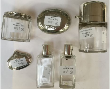 A silver topped gentleman's cologne bottle together with two similar bottles, a dressing table pot and two white metal snuff 