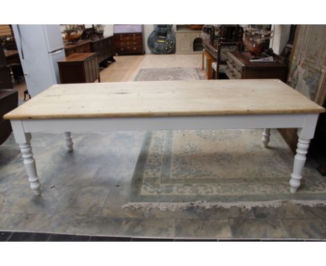  A contemporary pine topped and white painted kitchen dining table, standing on turned legs, 76cm high, 245cm wide, 98cm deep