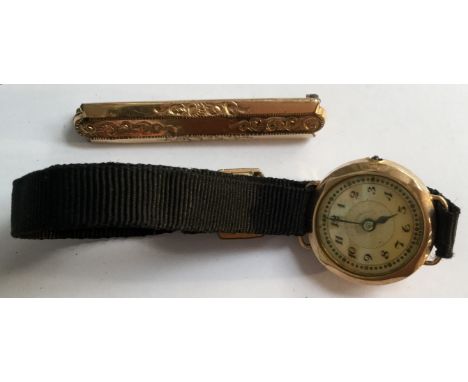 A circa 1920's 9ct gold and mother of pearl ladies watch with ribbon strap,  along with a yellow metal bar brooch