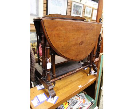 A late Victorian mahogany Sutherland table, each side with two turned supports, standing on platform bases