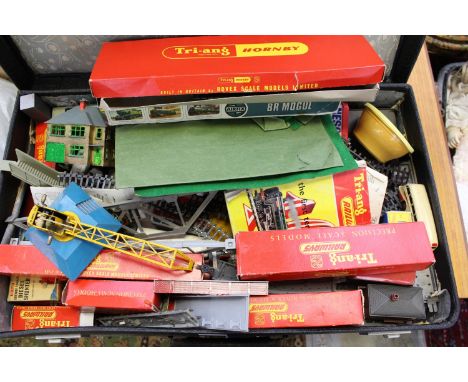 A suitcase containing 1950's and 60's Tri-ang Hornby model railway, including accessories, coaches and others, track, a boxed