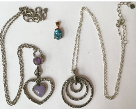Two silver marcasite and amethyst set pendants and chains; together with a blue topaz set, pendant  unmarked 