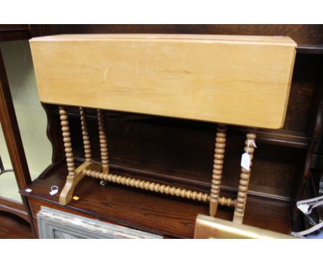 A Victorian stripped pine Sutherland table, raised on bobbin turned legs