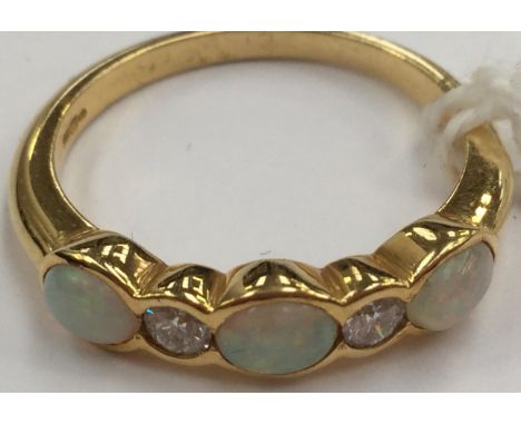 An opal and diamond band, set with three opals, with diamonds in between, size N½, total gross weight 3.7 grams approx