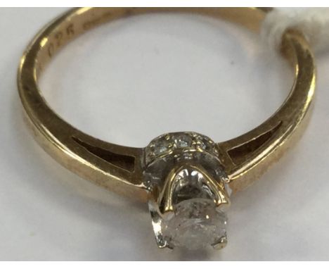 A diamond solitaire, claw setting with round brilliant cut diamond, with grain set small diamonds to the sides of setting, 18