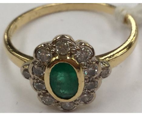 An emerald and diamond cluster ring, in 18ct gold, oval emerald, collet set with collet set surround of diamonds, size N½, to