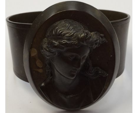 An early 20th Century bakelite mourning bangle, the mount in the form of a Classical lady, flexible cuff, approx size of came