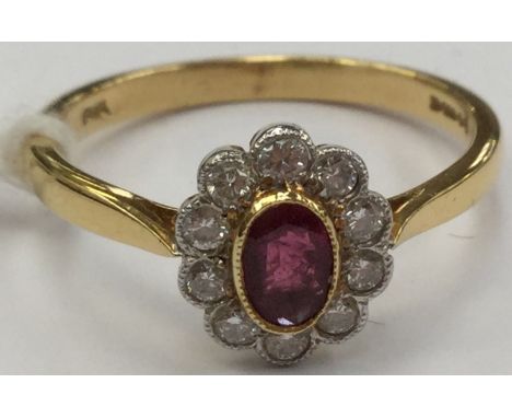 A diamond and ruby cluster ring, comprising an oval ruby, approx size approx 3mm x 4.5mm, with a surround of brilliant cut di