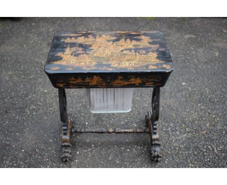 A Victorian black lacquered ladies work table, the lid enclosing fitted compartments, the whole decorated with gilded Japanes