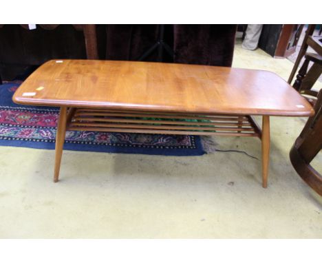 A collection of Ercol, comprising armchair with elm seat, a rocking chair and an elm topped coffee table (3)