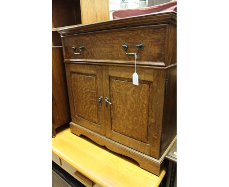 A collection of furniture comprising, a 20th Century oak TV cabinet, a single door record cabinet, a three sectioned oak book