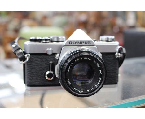 An Olympus OM-1 camera body complete with Olympus OM-System Zuiko MC Auto-S 1:1.8 f=50mm.