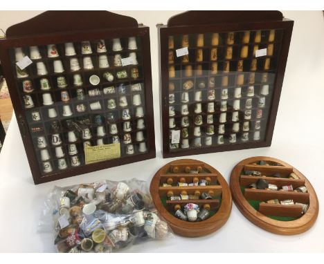 A large collection of thimbles, approx 303 in two large display cases and two smaller plaque displays, Royal Crown Derby pewt