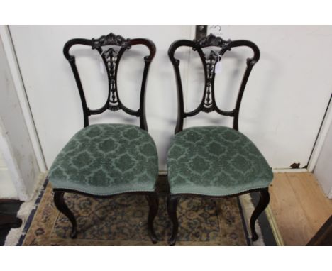 A collection of furniture, comprising a pair of late Victorian parlour chairs with carved backs, an Edwardian corner chair, a