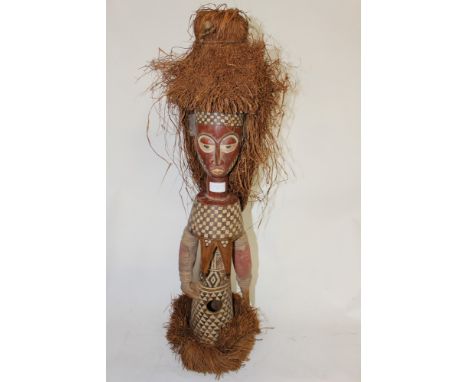 Kuba puppet from Democratic Republic of Congo, carved wood with painted decoration and straw hair 