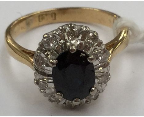 A sapphire and diamond cluster with illusion set diamond surround, 18 ct gold, size K, total gross weight 4 grams approx 
