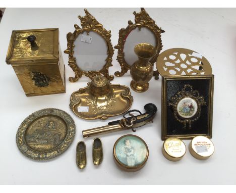 A brass tea caddy desk set with inkwell, two easel stand brass frames, trivet, weights, pistol, etc (one box) 