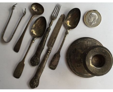 A collection of assorted silverware, comprising teaspoons, cake knife and fork, sugar tongs, Great War medal, inscribed 83036