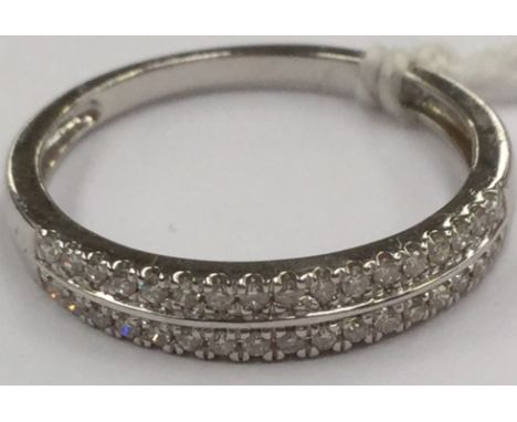 An 18k diamond double row band, set with small diamonds to the top, size S, total gross weight 2.8 grams approx 