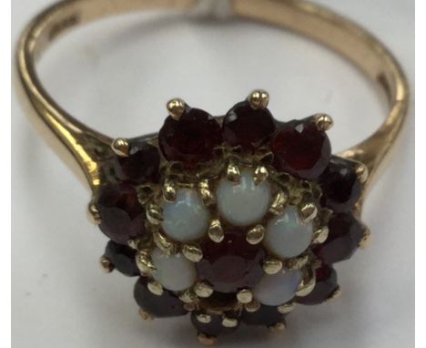 A garnet and opal cluster ring, (af) opal missing, set in 9ct gold size S, total gross weight approx 4.1gms