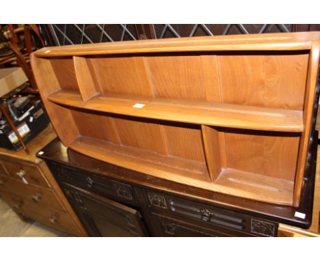 An Ercol light elm two-tier wall shelving unit