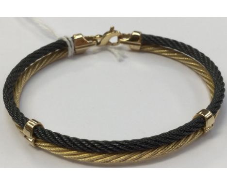 A titanium and 14k gold rope link ladies bracelet, with carabina fastener, approx diameter 6 cm, total weight approx 20.3 gra