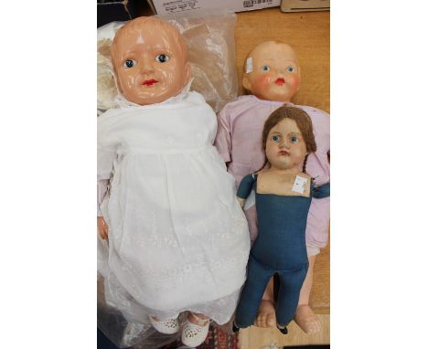 Celluloid doll, two others, various textiles and clothes 