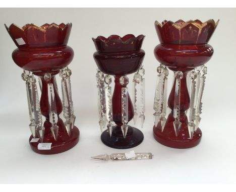 A pair of Victorian ruby glass lustres, s/d, together with a single, slightly smaller ruby glass lustre (3) 