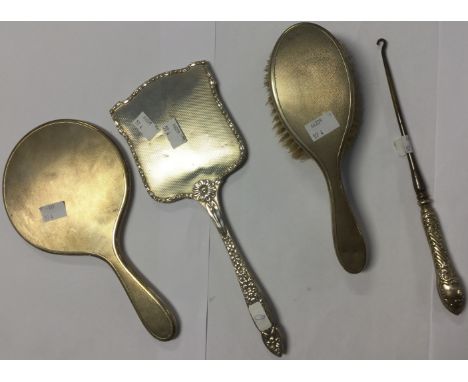 Three items of silver mounted dressing table appointments, mirror and brush matched, Birmingham 1945,  and a silver mounted b