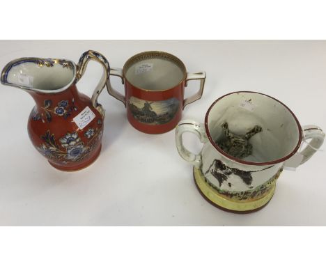 A 19th Century Prattware loving cup with landscape scenes; together with a similar jug and a large frog mug (3) 