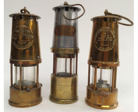 A Naylor Wigan safety miners lamp serial no. 6072, used condition; together with two projector type six miners lamps (3) 