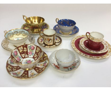 A collection of cabinet cups and saucers to include a Meissen duo, an Aynsley 'Orchard Gold' duo, gold interior to cup, three