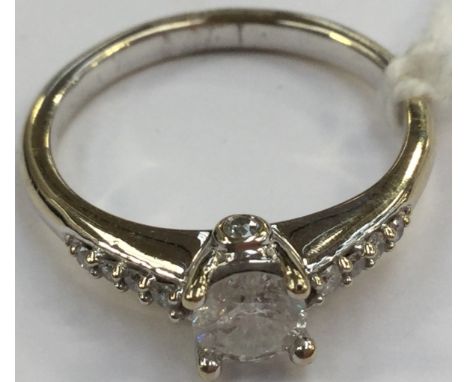 A diamond solitaire, with diamond claw set shoulders, the central claw set diamond weighing approx 0.40 carat, assessed clari