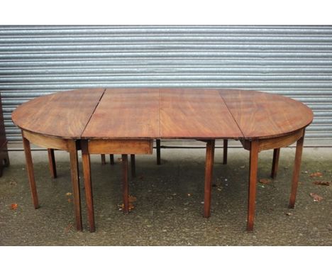 A George III mahogany dining table, circa 1790, comprising pair of D-ended sections and a single leaf drop-leaf table to cent