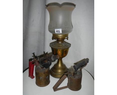An old brass oil lamp complete with chimney.