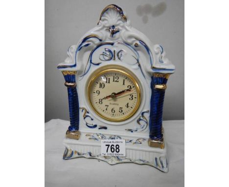 A blue and white quartz mantel clock.