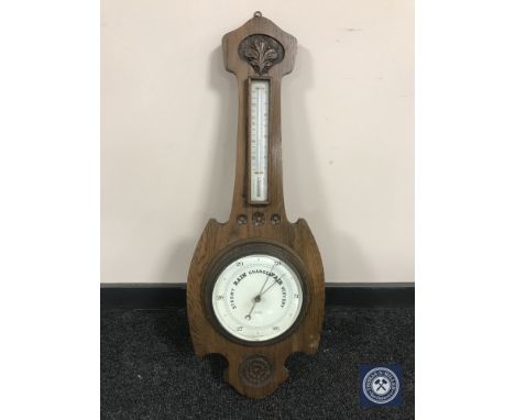A carved oak barometer
