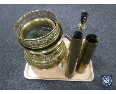 A tray of embossed brass planters, ammunition shells, lamp base etc