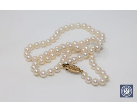 A cultured pearl necklace on 9ct yellow gold clasp