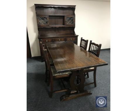 An oak refectory dining table together with a set of four oak tapestry seated dining chairs 