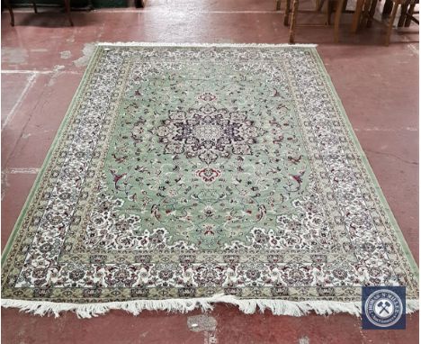 A Keshan carpet on green ground, 300 cm x 200 cm 