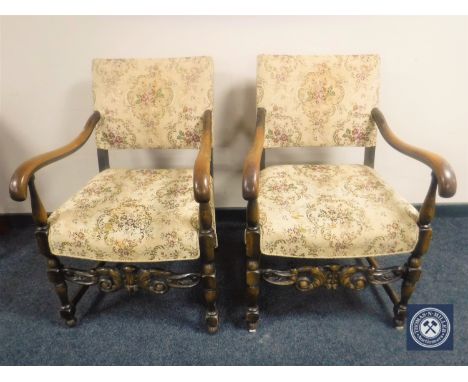 A pair of carved oak scroll armchairs in tapestry fabric 