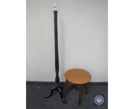 A carved mahogany standard lamp on tripod base together with a circular oak occasional table