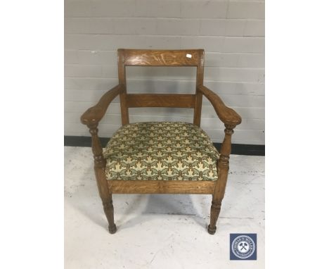 An early 20th century tapestry seated continental oak armchair 