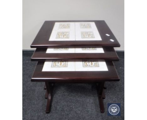 A nest of three tile inset tables