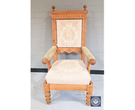 A blond oak framed armchair with tapestry back rest