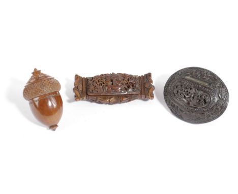 A COCONUT OVAL SNUFF BOX LATE 18TH CENTURY relief carved with scrolling leaves, a seated figure, a shield and musical trophie