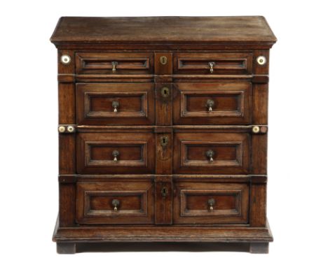 A CHARLES II OAK AND CEDAR CHEST C.1680 with four long drawers, with panelled fronts and applied ivory rondels 77.4cm high, 7