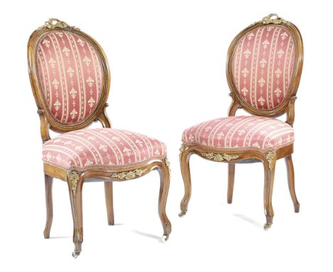A PAIR OF FRENCH WALNUT SALON CHAIRS IN LOUIS XV STYLE, MID-19TH CENTURY with ormolu mounts and ceramic castors (2)